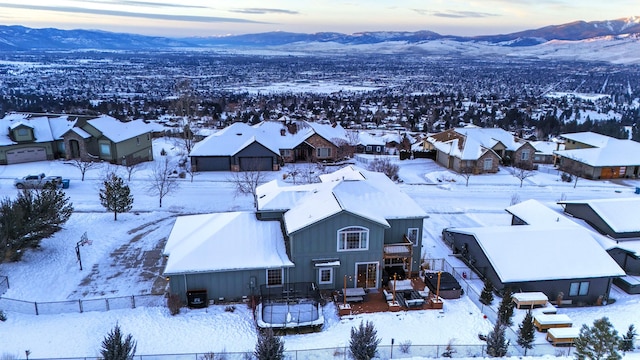 snowy aerial view featuring a mountain view