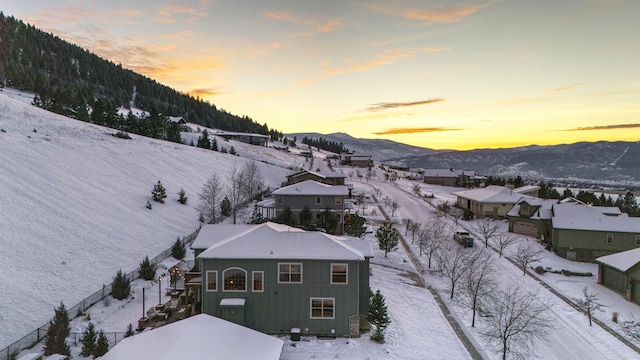 snowy aerial view with a mountain view