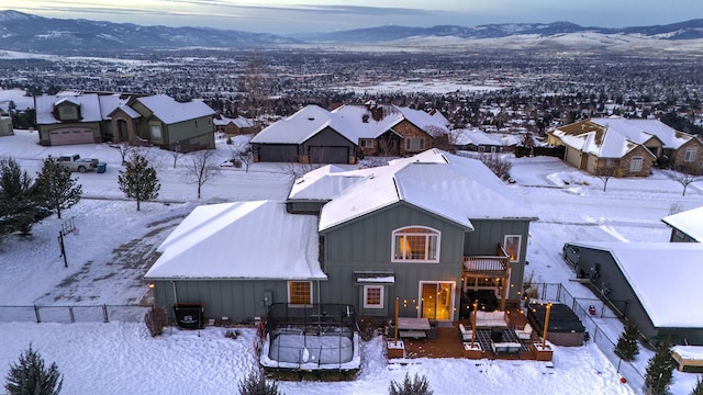 snowy aerial view with a mountain view