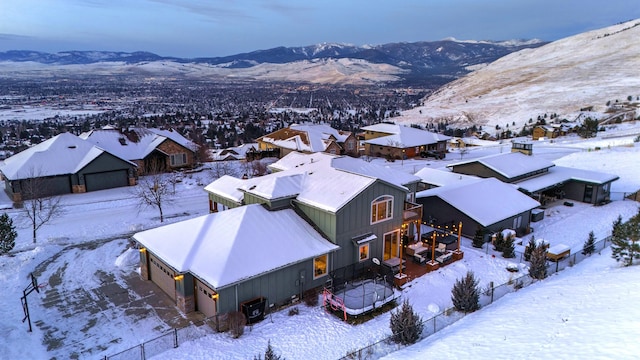 snowy aerial view featuring a mountain view