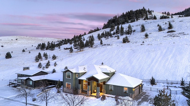 snowy aerial view with a mountain view