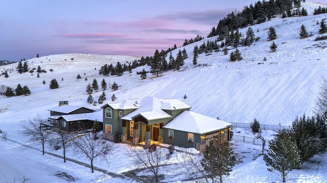 snowy aerial view featuring a mountain view