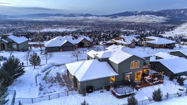 snowy aerial view with a mountain view