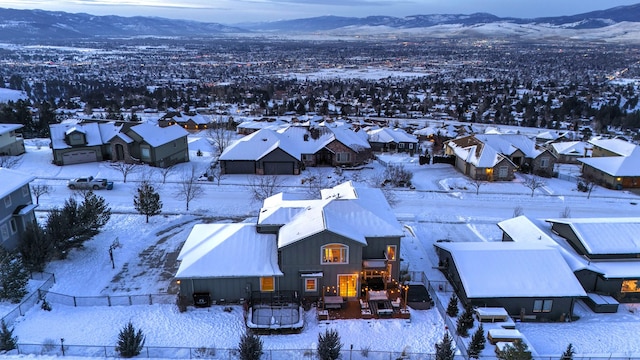 snowy aerial view featuring a mountain view