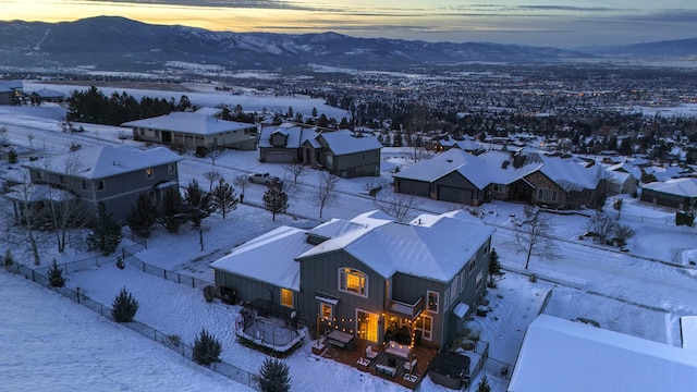 snowy aerial view with a mountain view