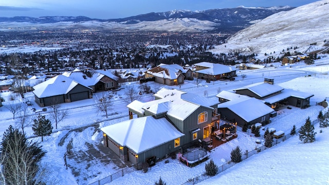 snowy aerial view with a mountain view