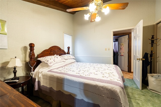 carpeted bedroom with wood ceiling, ceiling fan, and beamed ceiling