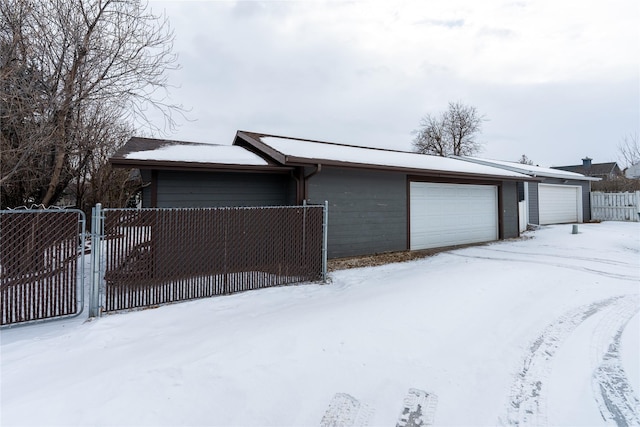 view of front of home with a garage and fence