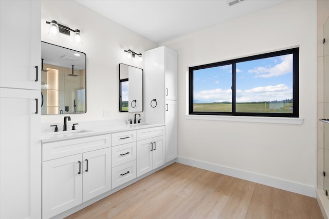 bathroom featuring vanity, an enclosed shower, and hardwood / wood-style floors