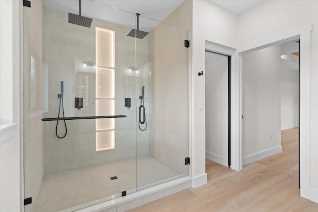 bathroom featuring hardwood / wood-style floors and an enclosed shower