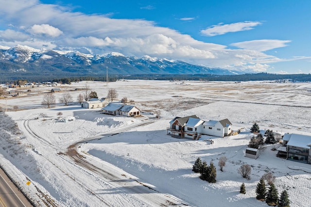 snowy aerial view featuring a mountain view