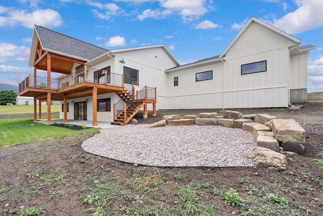 rear view of house with a wooden deck and a patio area