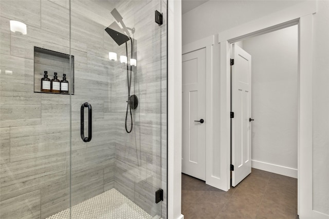 bathroom featuring a shower with door and tile patterned floors