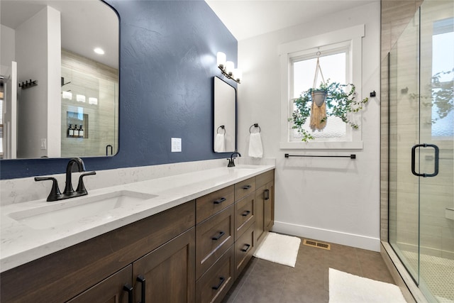 bathroom with walk in shower, vanity, and tile patterned flooring