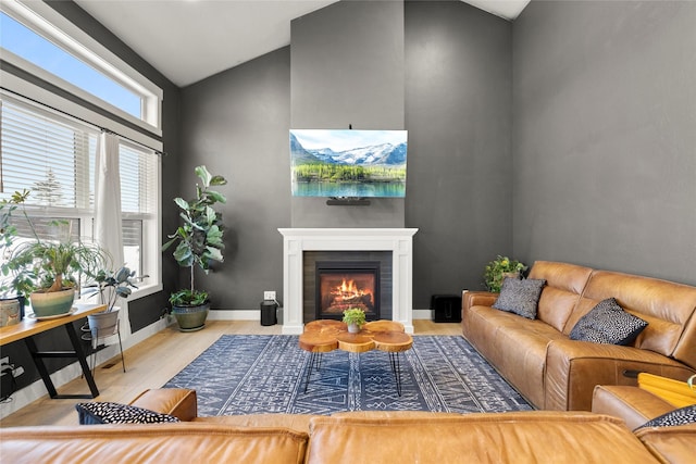 living room featuring lofted ceiling and light wood-type flooring