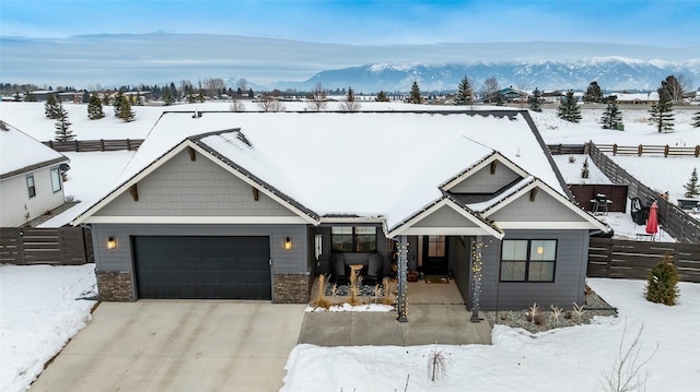 view of front of home with a garage and a mountain view