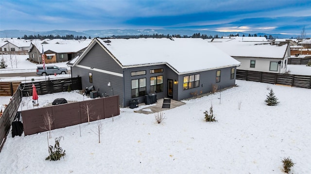 snow covered house with a mountain view