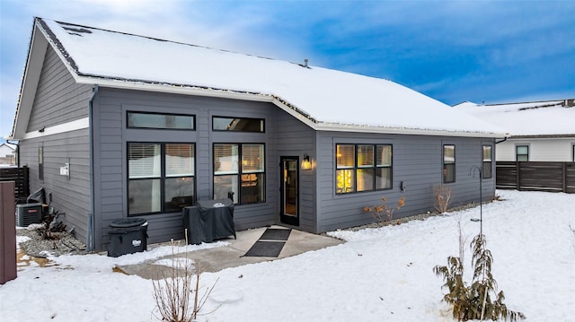 view of snow covered back of property