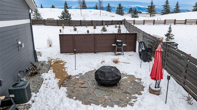 exterior space with central AC unit and an outdoor fire pit