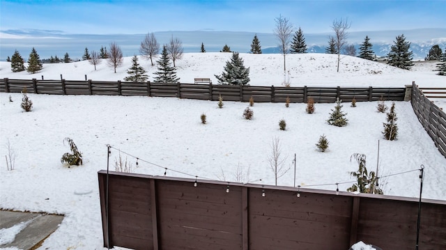 snowy yard with a mountain view