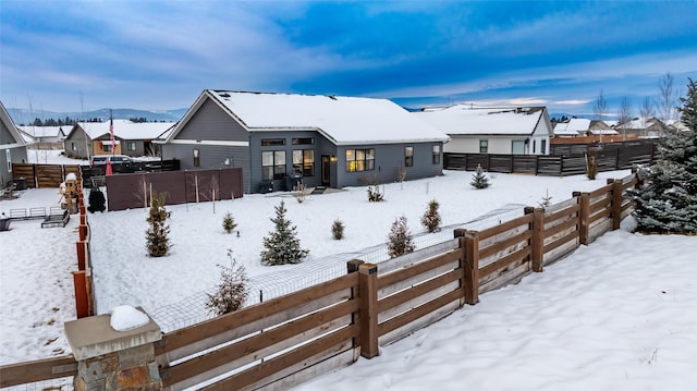 snow covered house with a mountain view