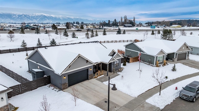 snowy aerial view featuring a mountain view