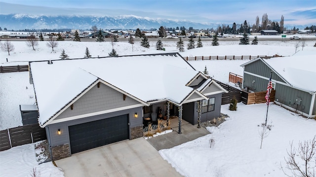 snowy aerial view featuring a mountain view