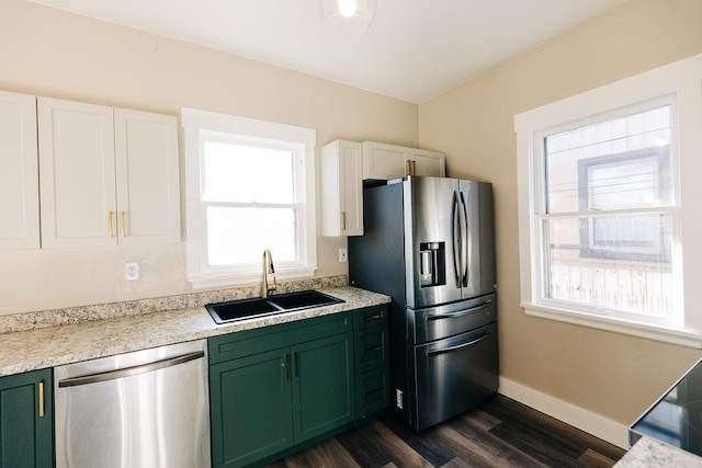 kitchen with sink, plenty of natural light, green cabinetry, and appliances with stainless steel finishes