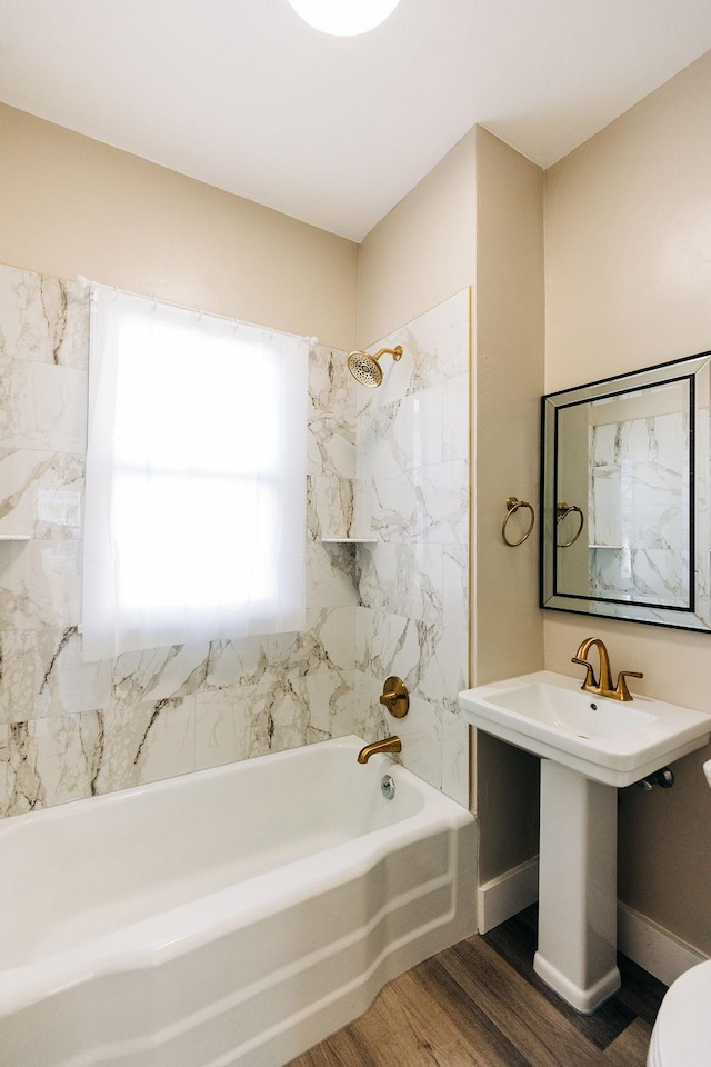 full bathroom featuring hardwood / wood-style floors, tub / shower combination, sink, and toilet