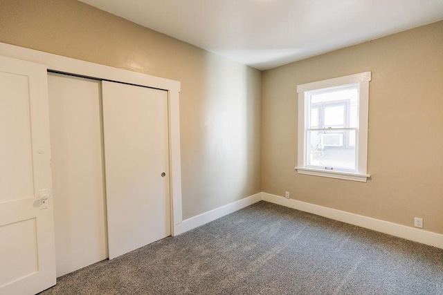 unfurnished bedroom with carpet floors and a closet