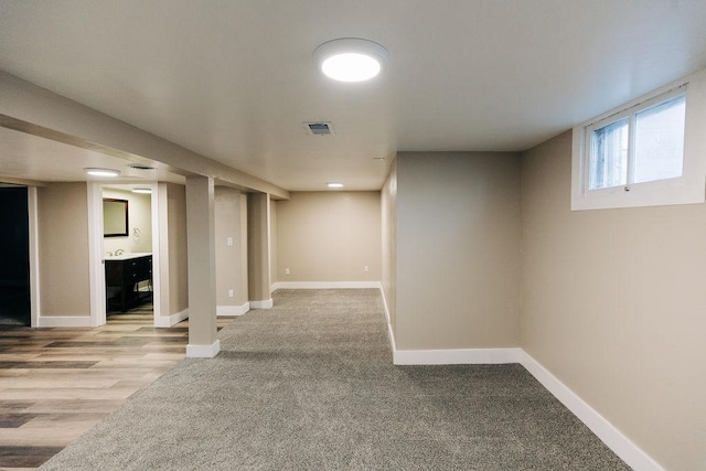 basement featuring light carpet