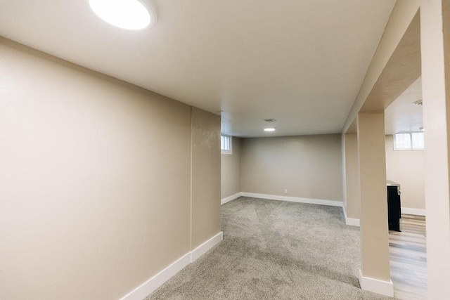 basement featuring light colored carpet