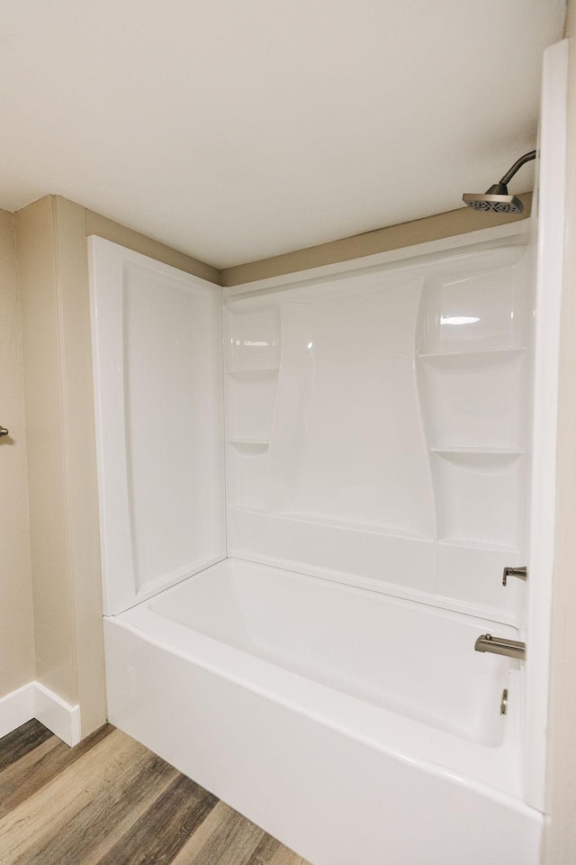 bathroom featuring shower / bathing tub combination and wood-type flooring