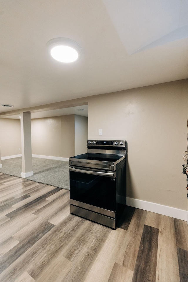 interior space with stainless steel range with electric stovetop and light hardwood / wood-style flooring