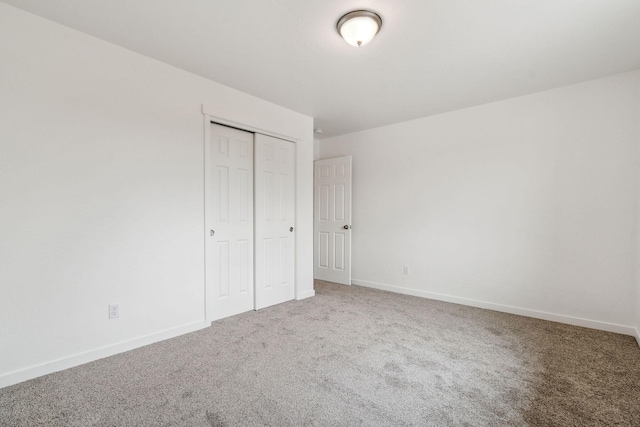 unfurnished bedroom with a closet and carpet