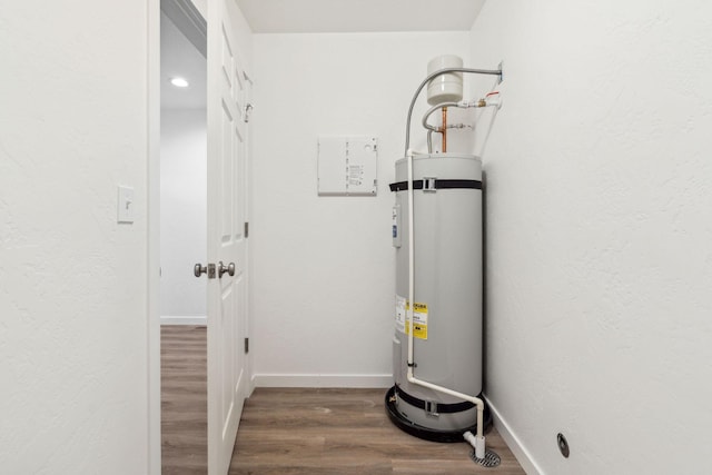 utility room featuring strapped water heater