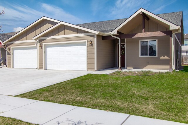 view of front of home with a garage and a front lawn