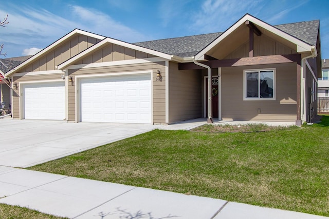 view of front facade with a garage, a front lawn, concrete driveway, roof with shingles, and board and batten siding