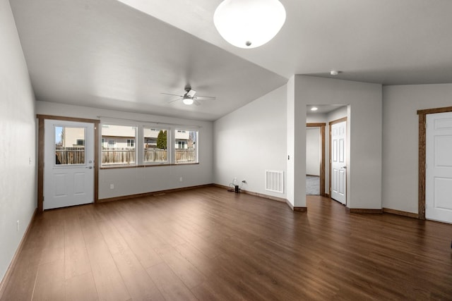 unfurnished living room with ceiling fan, dark wood-style floors, baseboards, and vaulted ceiling