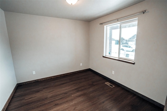 unfurnished room with dark hardwood / wood-style floors