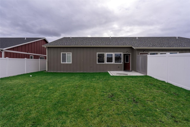 rear view of property featuring a lawn and a patio area