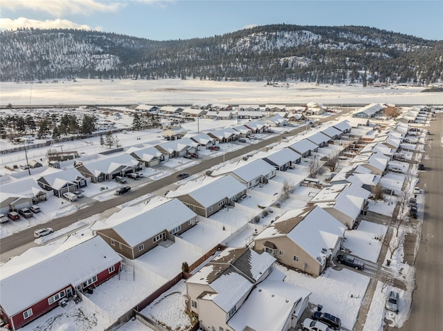 snowy aerial view featuring a mountain view