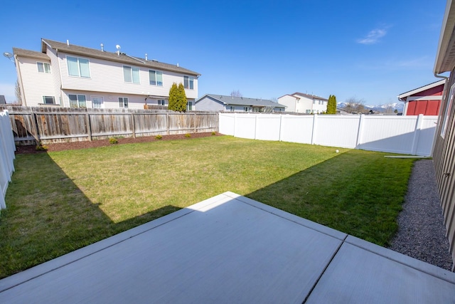 view of yard featuring a patio area and a residential view