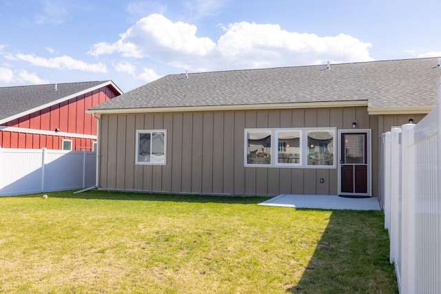 rear view of property with a shingled roof and board and batten siding