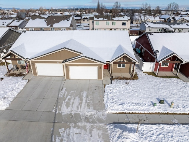 snowy aerial view with a residential view