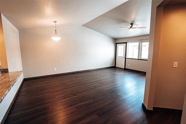 spare room featuring ceiling fan, dark hardwood / wood-style flooring, and vaulted ceiling