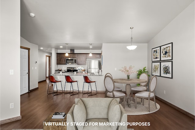 dining space with baseboards, dark wood finished floors, and recessed lighting