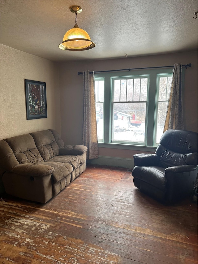 living room with dark wood-type flooring and a textured ceiling