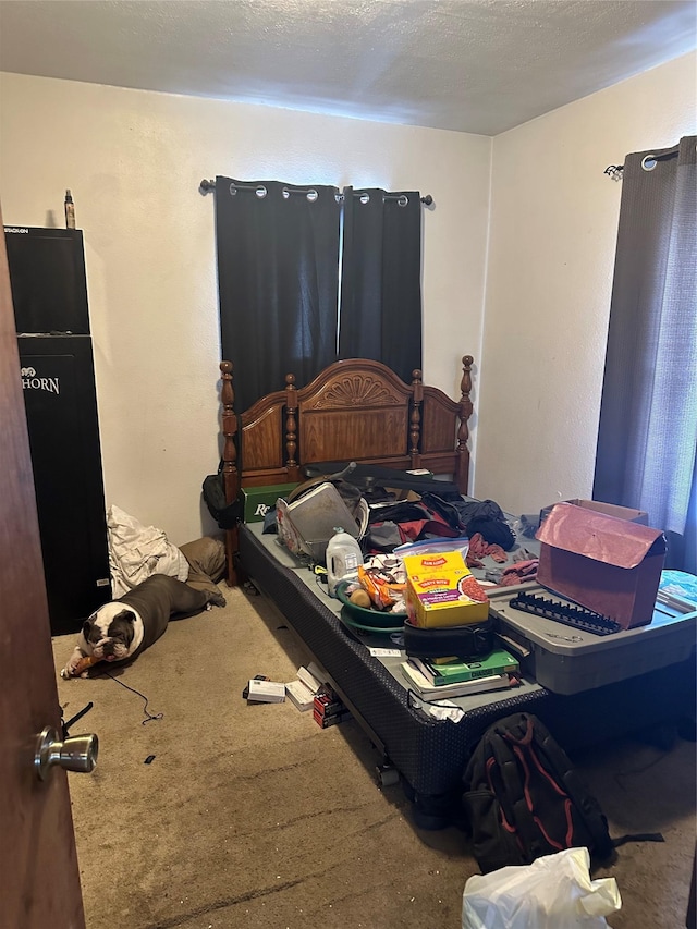 bedroom featuring carpet floors and a textured ceiling