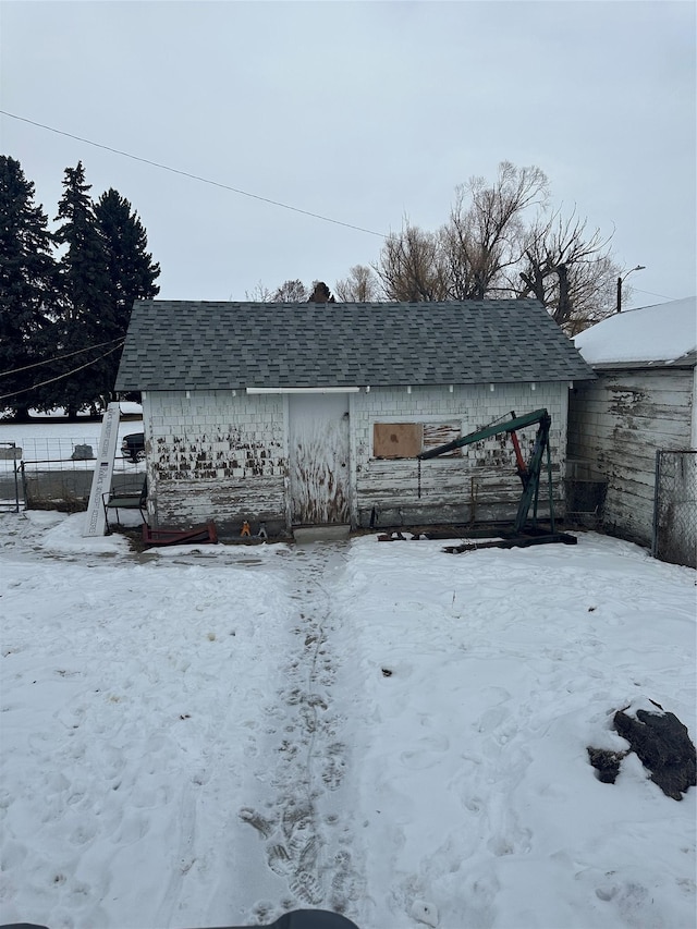 view of snow covered rear of property